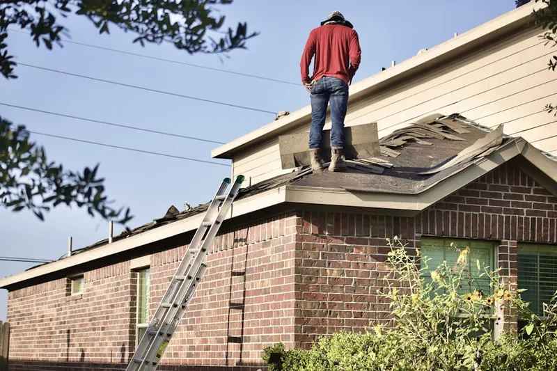 Professional roofer working on a residential roof in West Belleview